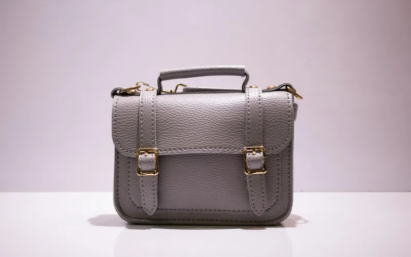 Grey leather top-handle satchel with gold buckles