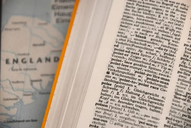 italki: pay-as-you-go language lessons with teachers in 150+ languages An open English dictionary lying flat in natural light