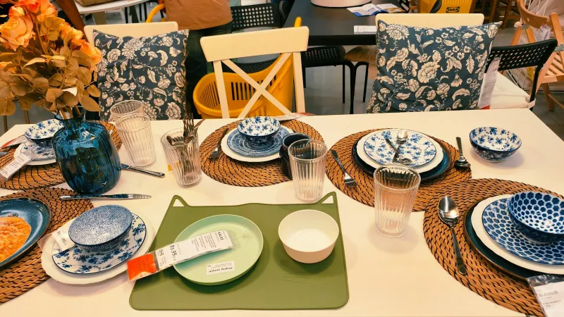 Dining table set with blue patterned plates, bowls and glasses