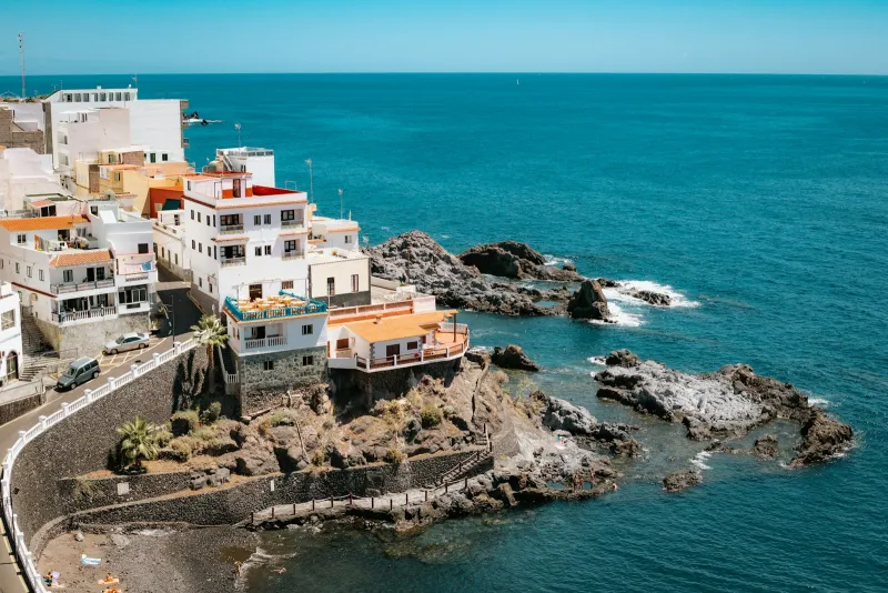 White houses on a rocky headland above the deep blue Atlantic at Los Gigantes, Tenerife