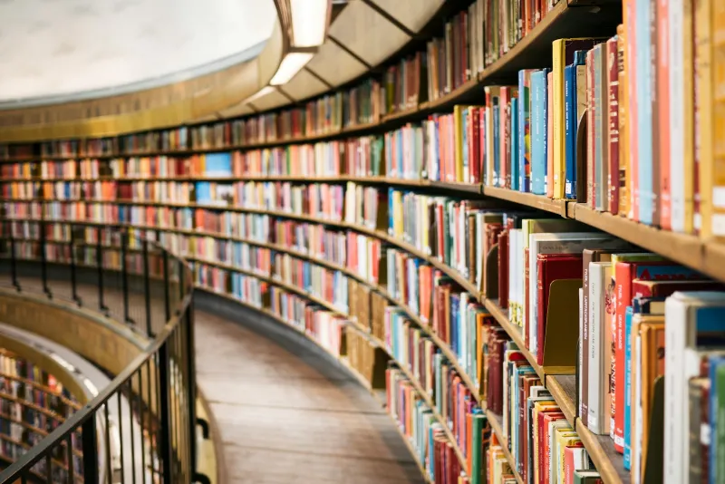 Curved library shelves filled with colourful books