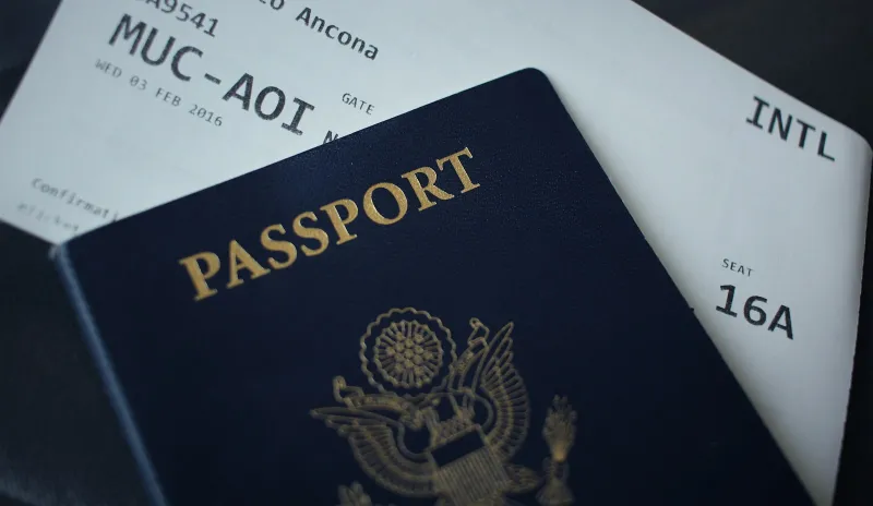 A passport resting on a printed boarding pass