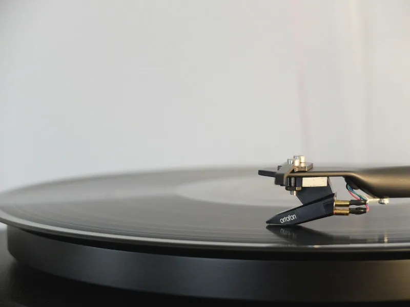 A black vinyl record on a turntable