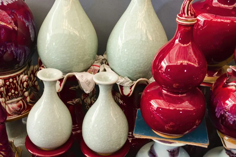 Collection of glazed ceramic vases in pale green and deep red