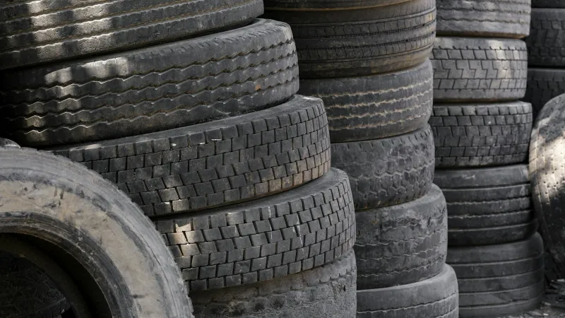 Stacks of car tyres piled up side by side