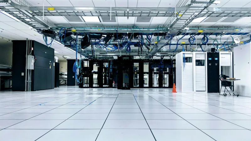 netart.com: domains, hosting and business email with first-period promos Rows of server cabinets in a data centre with blue cables overhead