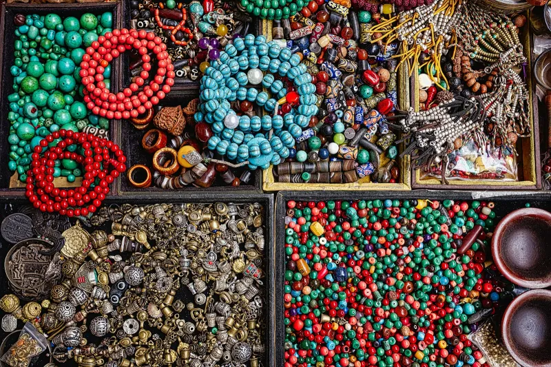 Trays of colourful beads, metal findings and beaded strands