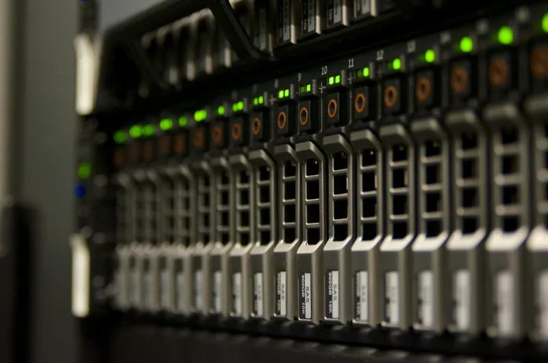 A server rack in a data centre with rows of blinking green lights
