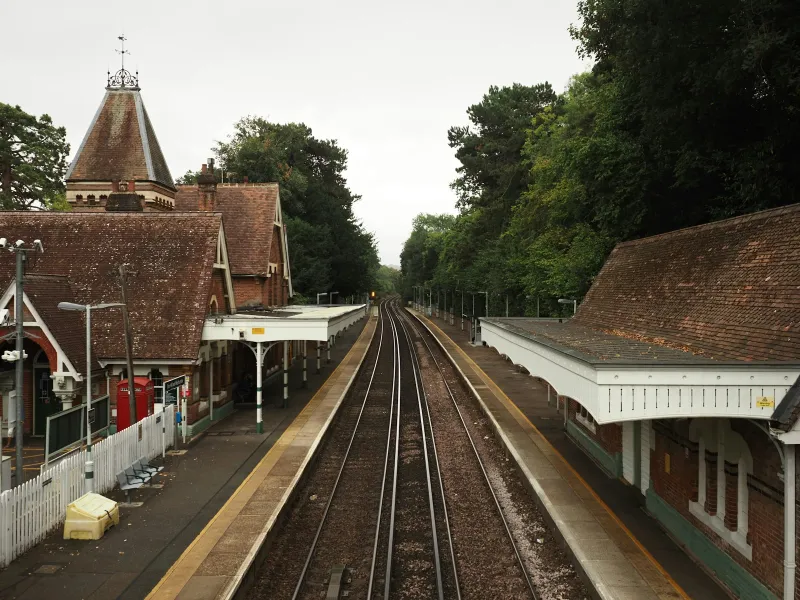Historic brick railway station with two platforms and tracks