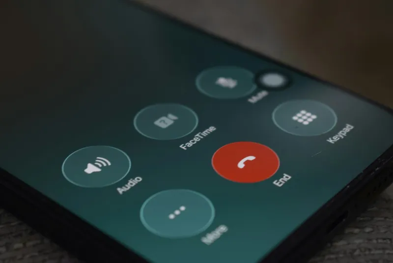 Close-up of a smartphone screen during a call, with the red end-call button
