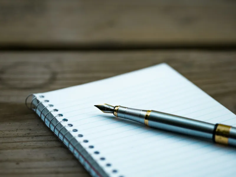 Squiggle Consult: Wills, Powers of Attorney and the complimentary Will scheme A fountain pen resting on an open spiral notebook