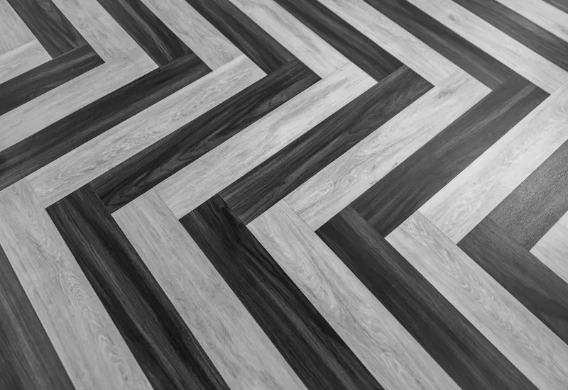 Close-up of wooden floor planks laid in a herringbone pattern