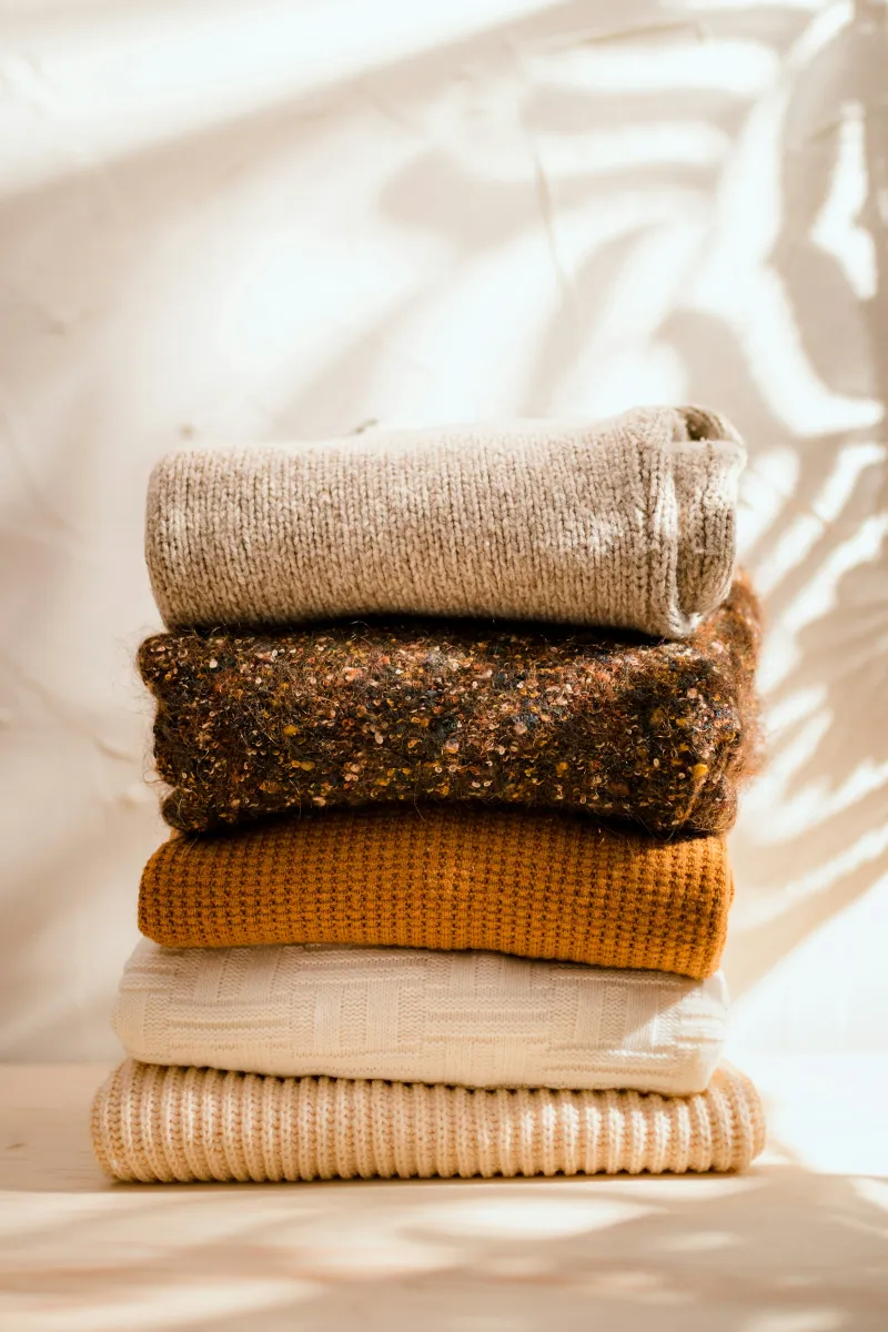 Stack of folded knitted jumpers