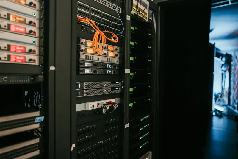 Racks of network and server equipment in a dark room