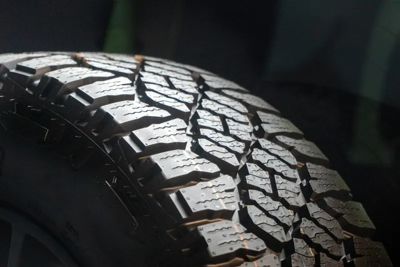 Close-up of a deep tyre tread on a dark background
