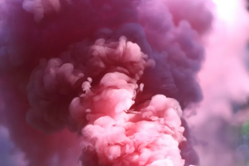 Billowing clouds of pink and purple smoke