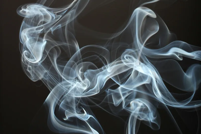 Swirling wisps of pale blue-white vapour against a black background