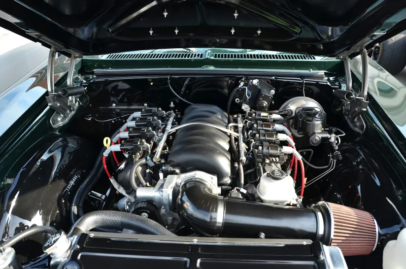 A car's engine bay with the bonnet propped open