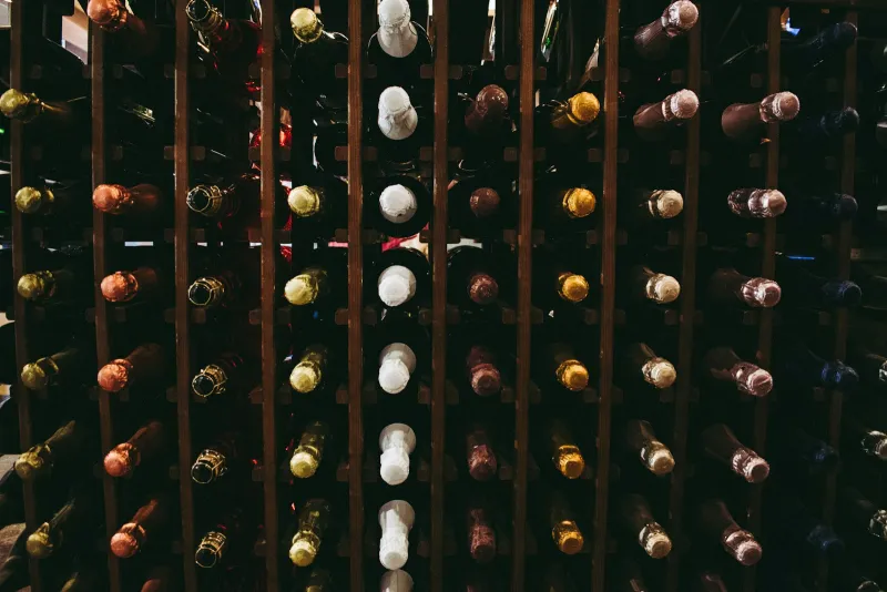 Winebuyers: wine, beer and spirits direct from independent sellers Rows of wine and sparkling wine bottles stored in a wooden rack