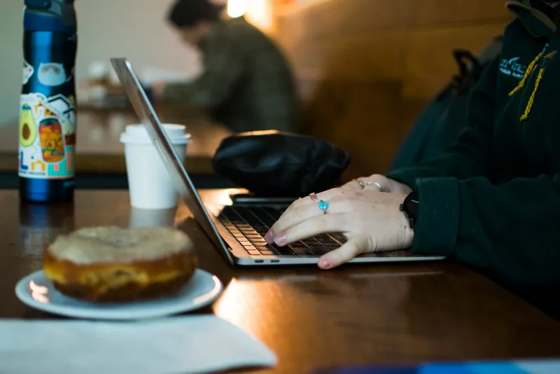 WiTopia: personalVPN, free email encryption and plug-and-play VPN routers Hands typing on a laptop at a café table next to a coffee cup