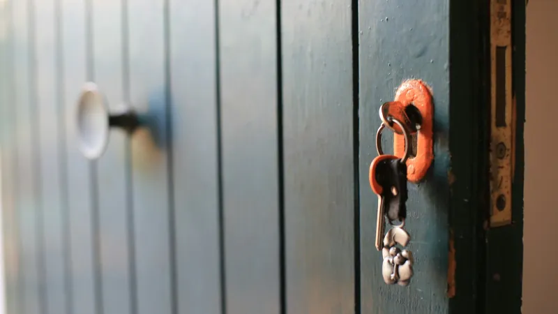 Yale: smart locks, alarms and safes direct from the lock maker A bunch of keys hanging from the lock of a painted wooden door