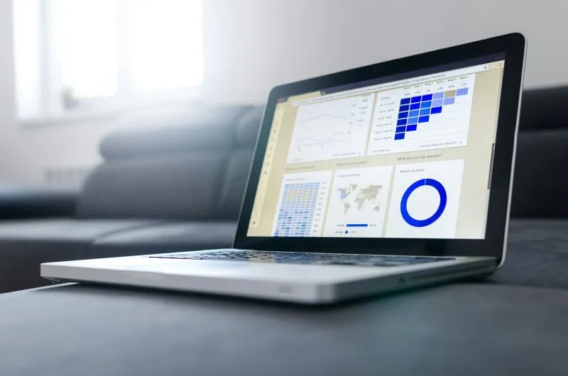 Your Company Formations: setting up a UK limited company from £2.48 Open laptop showing business charts on a grey sofa